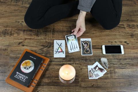 Image of person laying out tarot cards